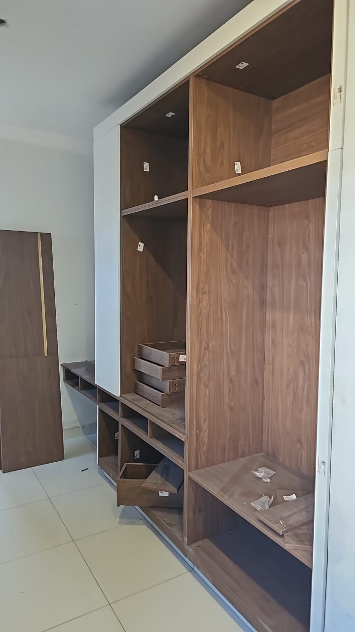 Walnut-tone wardrobe interior with drawers and hanging sections